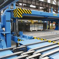 [Translate to English:] Blechpaket-Wendeeinrichtung mit hydraulischer Klemmung und motorisch angetriebenem Rollengang