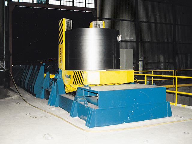 Transport unit for transporting and turning coils automatically